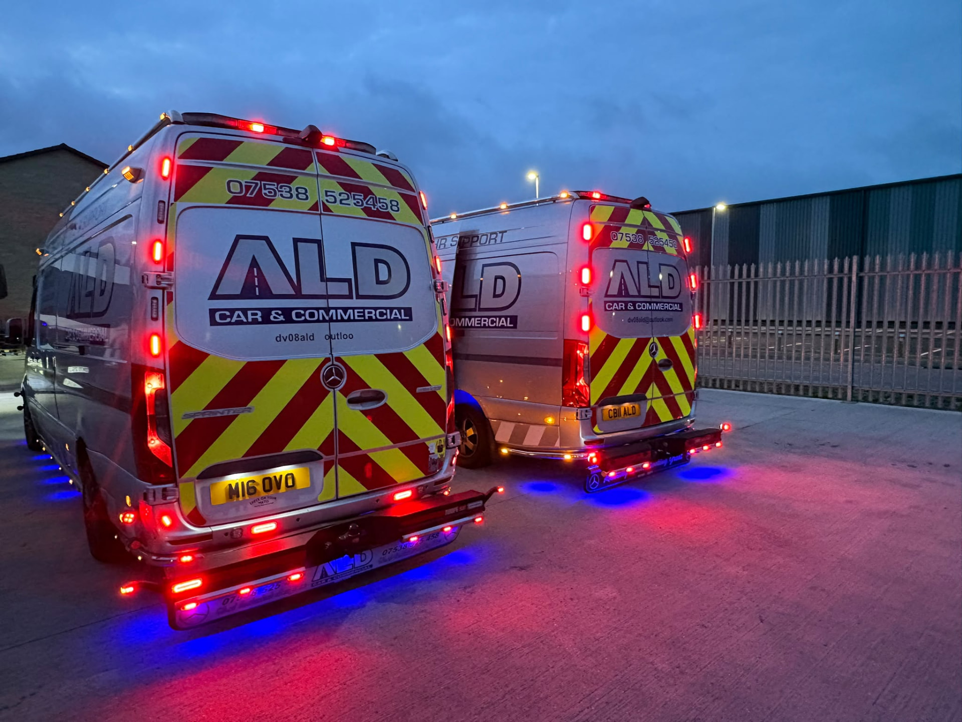 Two ALD vans lit up at night with hi-vis chevron livery