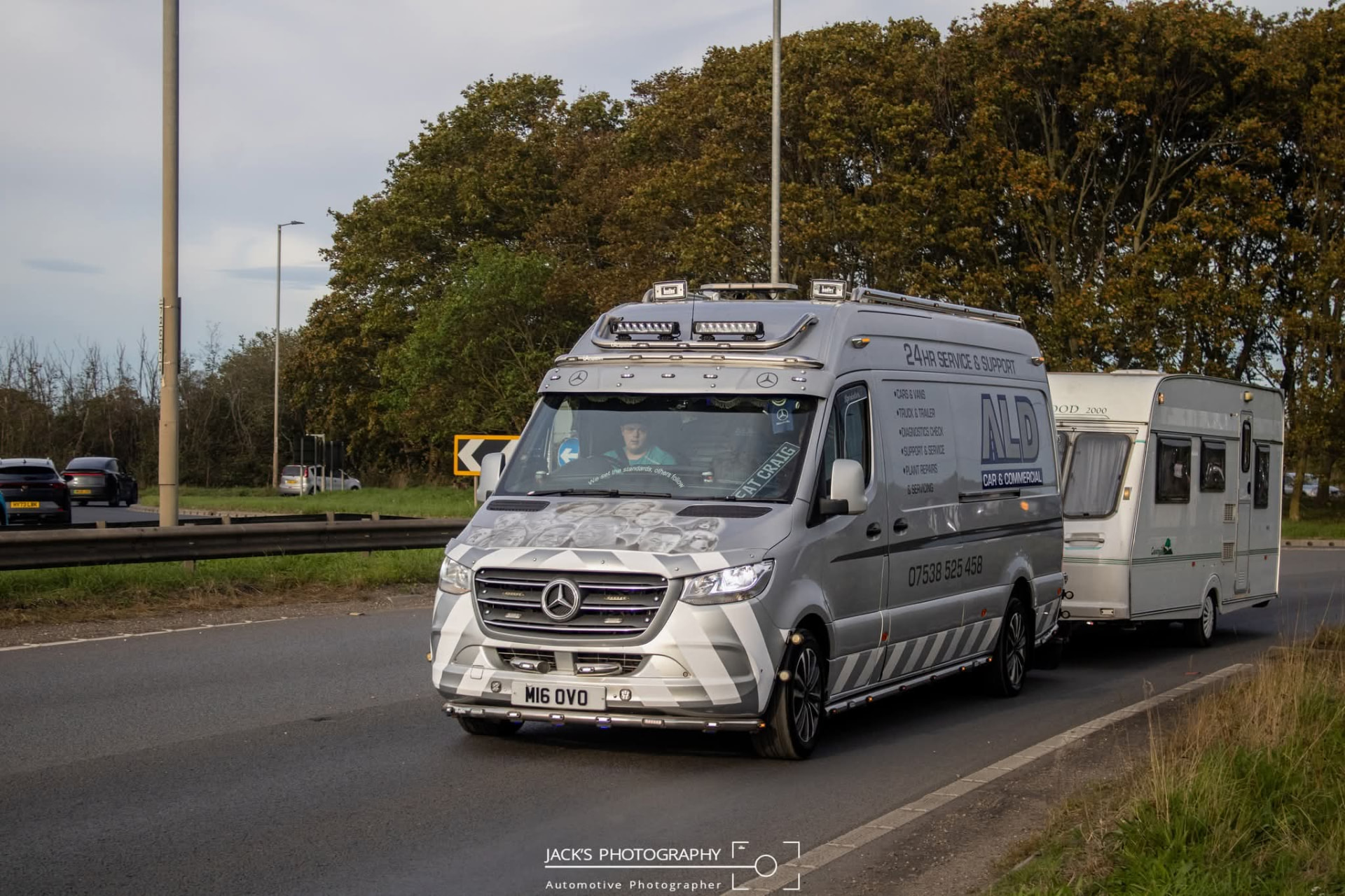 An ALD Mercedes Sprinter service van towing a caravan along the A19